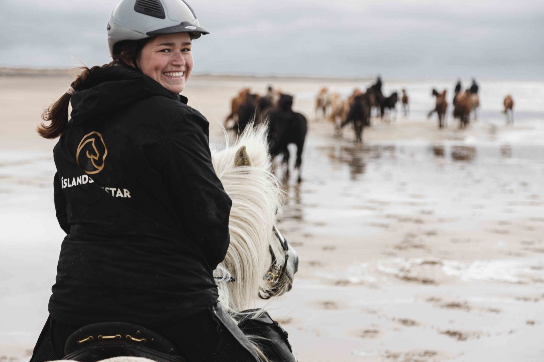 A beautiful smiling woman riding in Snæfellsnes