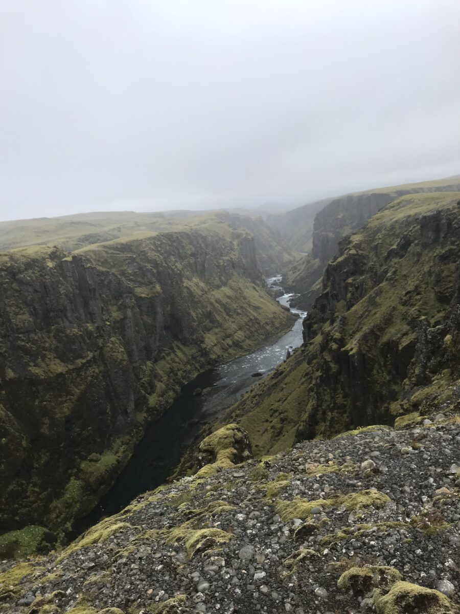 deep volcanic canyon in Iceland carved by a milky glacial stream